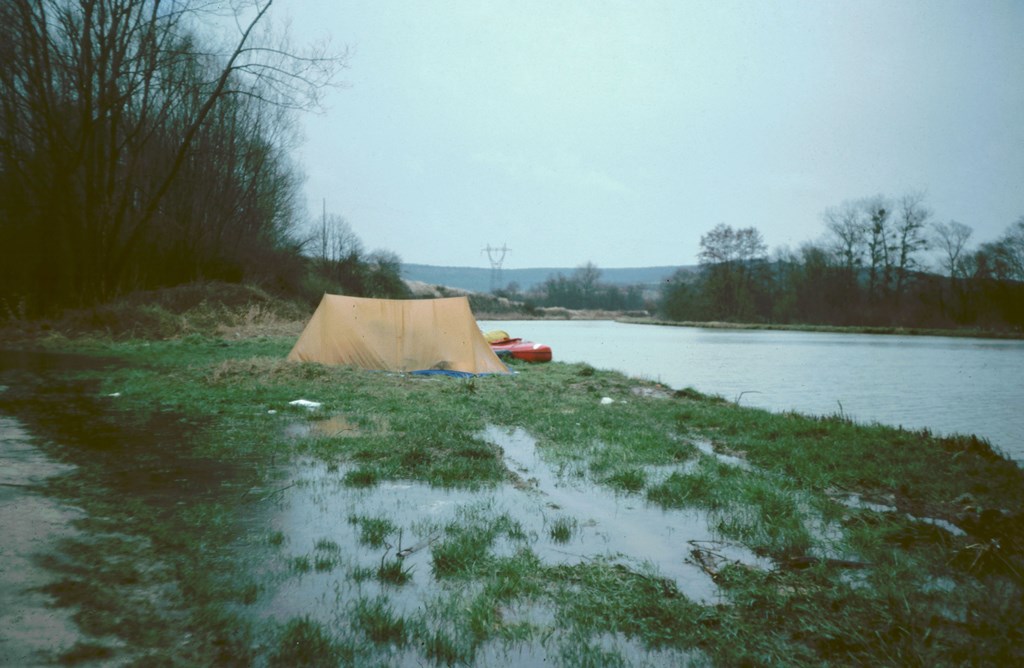 Camping with kayak on waterlogged canal bank France 1979